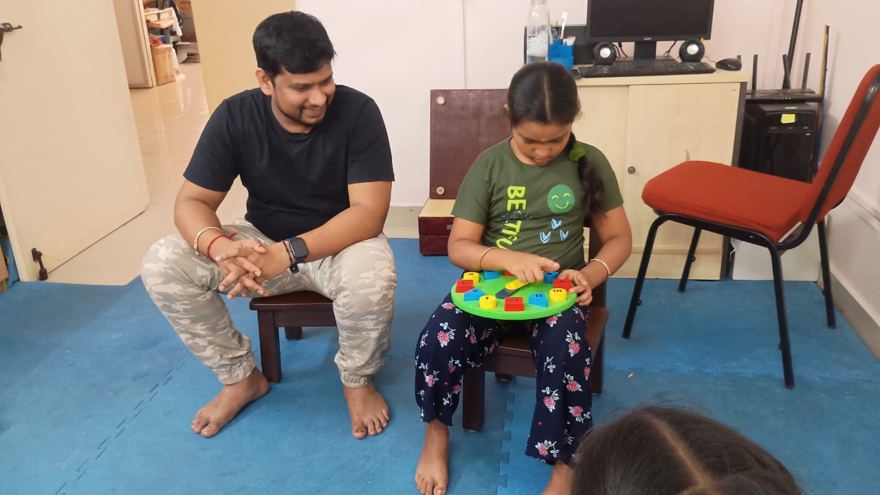 A young child participating in an Early Intervention activity with a therapist